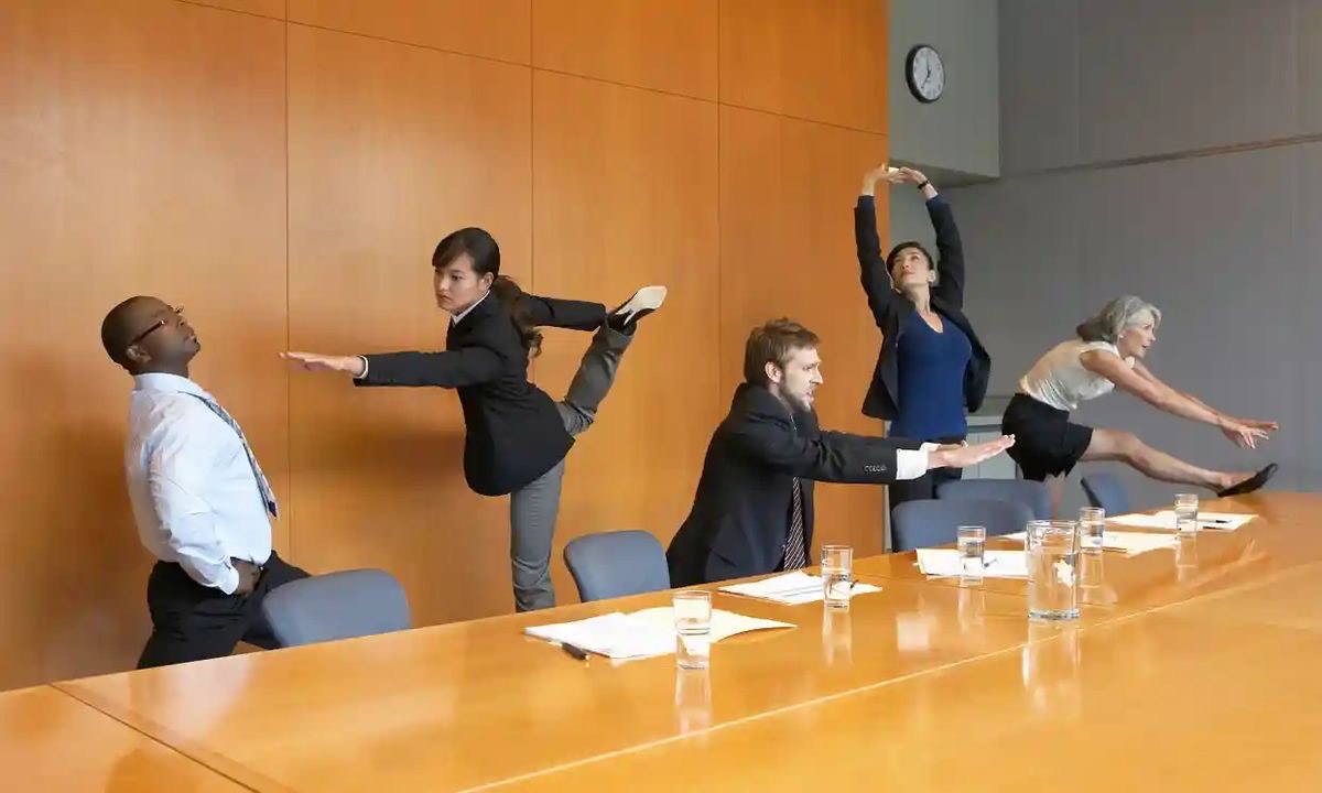 Corporate Wellness Day - Professionals practicing yoga in a conference room